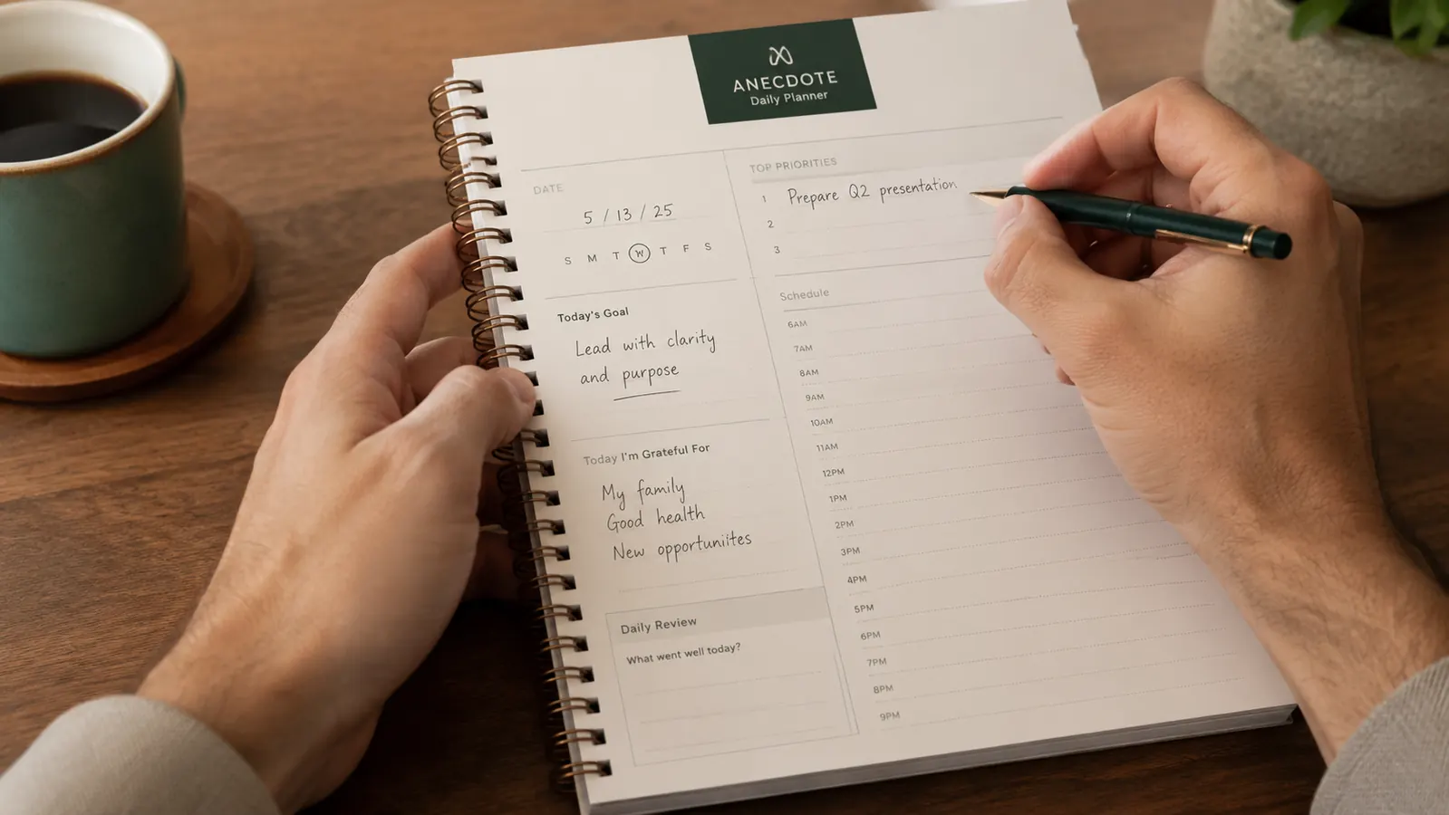 Hand writing priorities into the Anecdote Daily Planner morning planning section