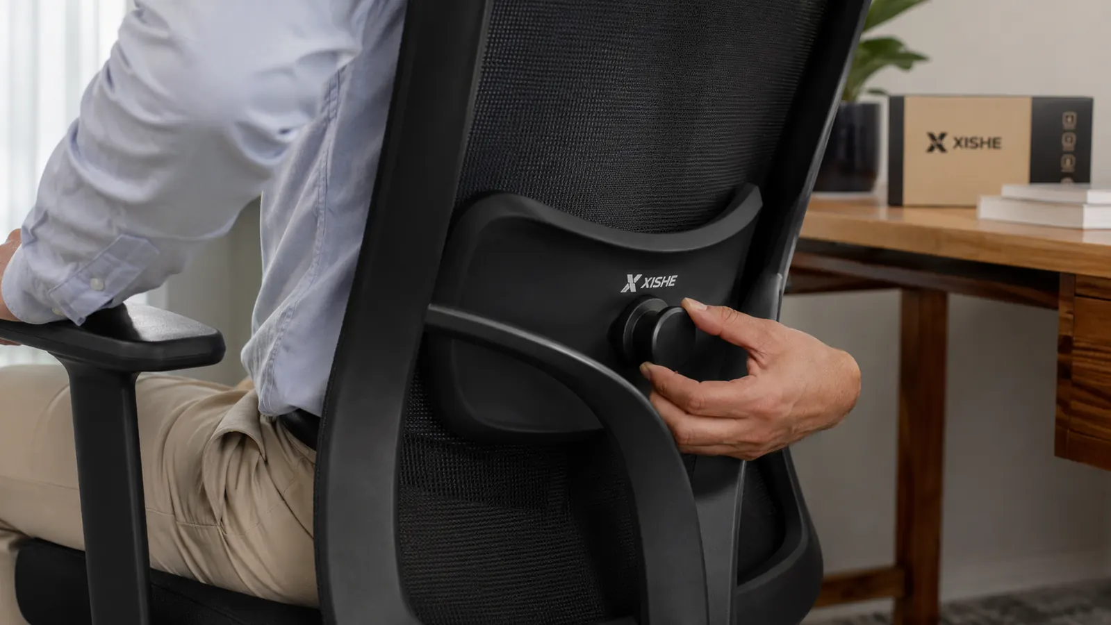 Close-up of ergonomic office chair lumbar support and mesh back panel in a home office setting